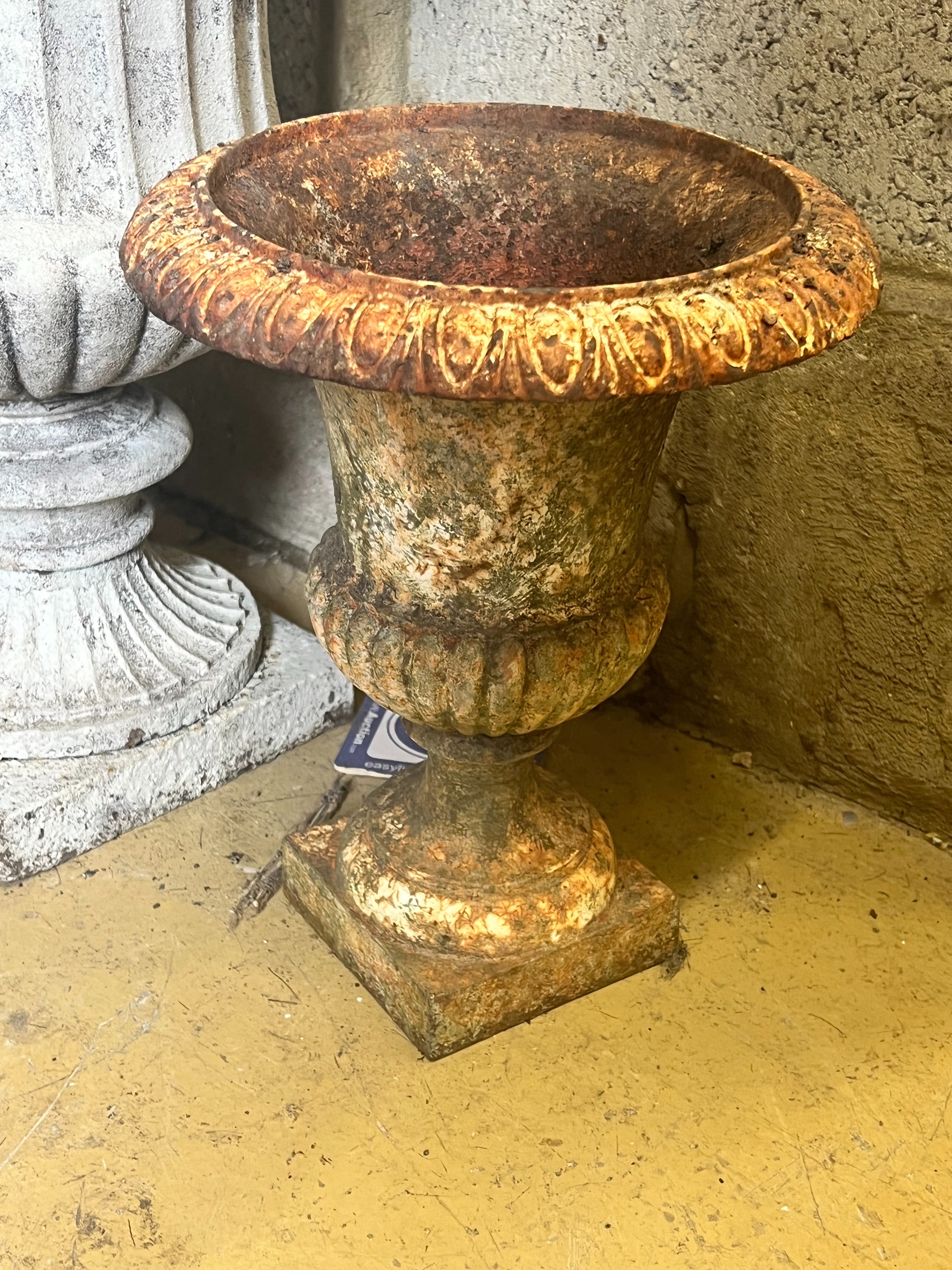 A pair of cast iron campana garden urns, larger diameter 39cm height 48cm